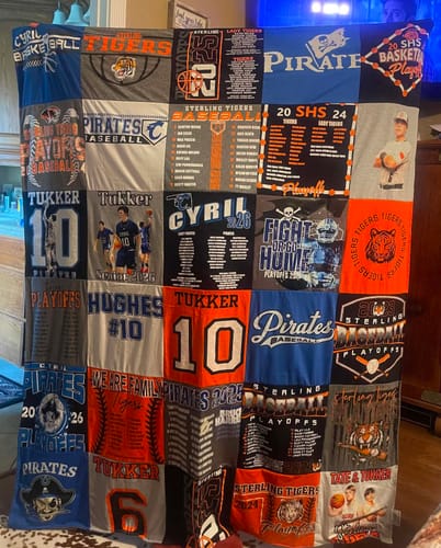 Customer's large Project Repat T-Shirt Quilt made from a collage of blue, orange, and grey sports jerseys.