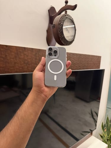 Customer holding an iPhone 15 Pro to show the back view of the Anti Yellow Magsafe Clear Case.