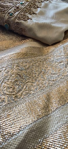 Customer's close-up of the Amelia dress, showing the detailed brocade fabric and golden sfifa embroidery.