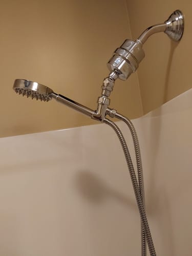 Customer's shiny Shower Head Filter installed in a shower with a handheld shower head attachment.