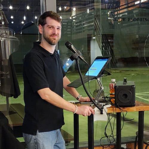 Customer using the Model-X 2.0 Stand to hold a laptop for an event.