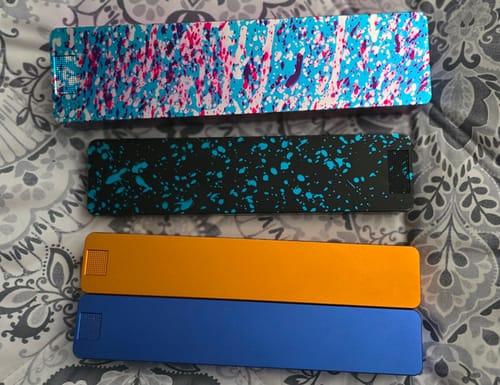Customer's four Weekly Cases in two solid colors and two colorful splatter designs.