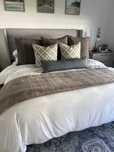 Customer's white Duvet Cover Set on a bed, styled with decorative pillows and a throw blanket in a cozy bedroom.