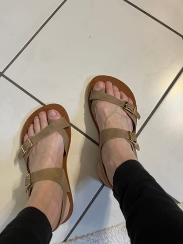 Reviewer's feet wearing the tan Glow II - Barefoot Sandals on a tiled floor, showing the fit and straps.