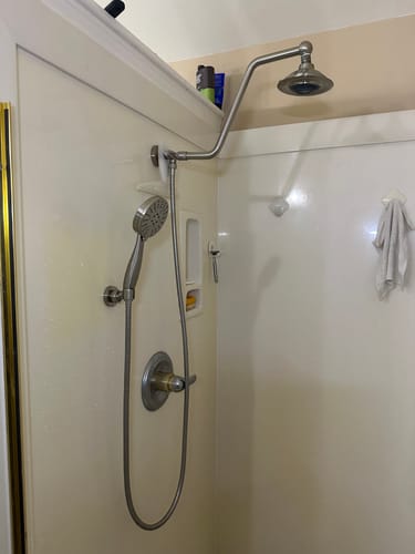 Reviewer's satin Handheld Shower Head installed in a shower stall, blending with existing shower fixtures.