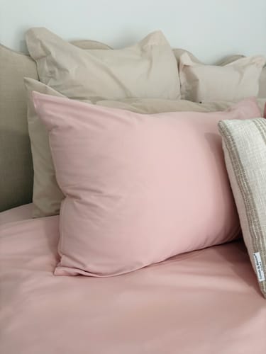 Close-up of a reviewer's pink Momomi® Anti-Allergy Bedding pillowcase and duvet.