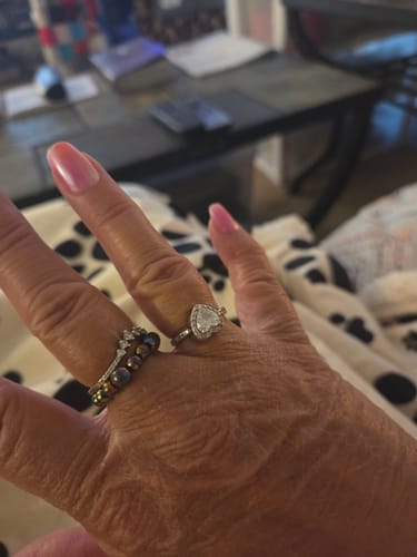 Customer's hand wearing the silver, heart-shaped Forever In My Heart Urn Ring.