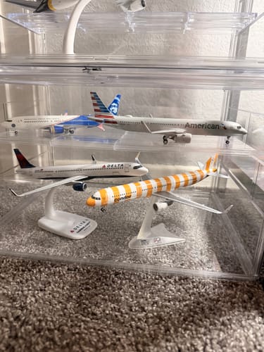 Customer's American A321neo model airplane displayed as part of a collection in a clear case.