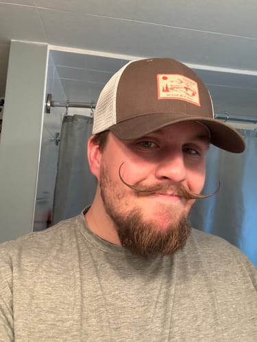 Reviewer wearing the brown Big Trucker Hat with a white mesh back.