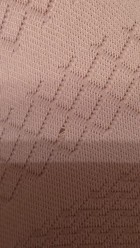 Close-up of a customer's purple 3D Anti-Cellulite Leggings showing a small hole in the textured fabric.