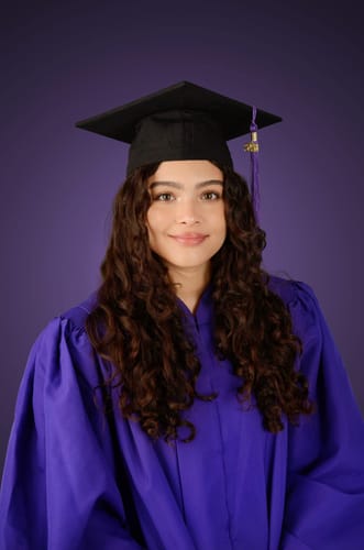 Reviewer's graduation photo showing her defined, curly hair after using SET Gel-To-Foam Styling Mousse.