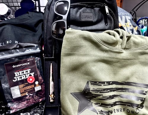 Customer's Mystery Loaded Backpack shown with the included green hoodie, sunglasses, and other branded gear.