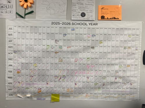 Customer's large School Year Calendar on a wall, filled with colorful handwritten notes and appointments.