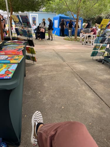 Customer's perspective of their leg in the Rasha Denim Joggers at an outdoor market.