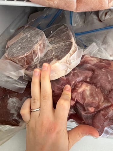 Close-up of a customer's freezer showing multiple vacuum-sealed bags of Beef Shank.