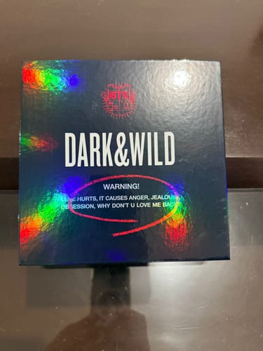 Customer's photo of the BTS 'DARK & WILD' album, showing the dark, holographic packaging.