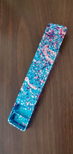 Reviewer's open Weekly Case in a colorful Cherry Blossom finish resting on a wood surface.