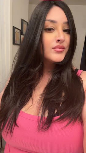 Customer shows her Natural Black Silk Topper styled with soft, face-framing layers for a natural look.