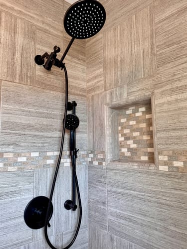 Customer's black Slide Bar with Shower Head Holder and dual shower head installed in a modern, tiled shower.