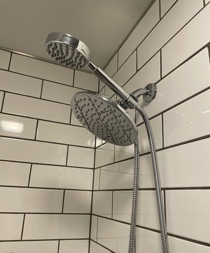 Customer's 1-Spray Dual Shower Head Set installed in a shower with white subway tiles.