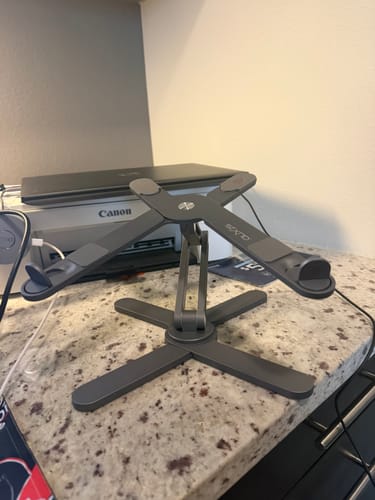Reviewer's dark grey Model-X 2.0 Stand shown empty on a countertop.