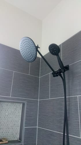 Customer's black Dual Shower Head with adjustable arm installed in a tiled shower.