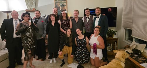 Customers in 1920s costumes enjoying the Murder Mystery Game Kit at a house party.