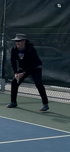Customer on a pickleball court in a low athletic stance wearing MUUV Flow shoes.