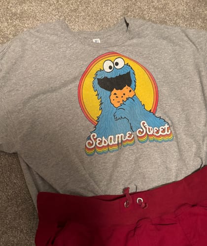 Reviewer's grey Retro Cookie Monster t-shirt laid flat, showing the colorful graphic of Cookie Monster eating a cookie.