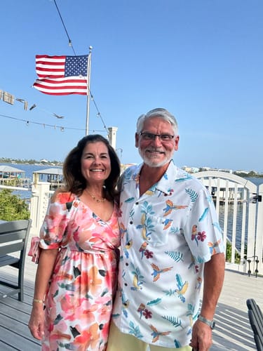 Reviewer with another person on a deck, with the Ultra Heavy Duty American Flag waving in the background.