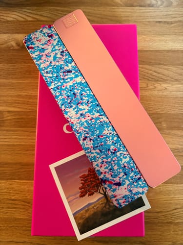 Customer's two 2-Week Vitamin Cases 2.0 in pink and a blue splatter pattern, shown on top of the product box.