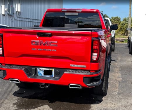 Customer's red GMC Sierra with a wider wheel stance after installing the wheel spacers.