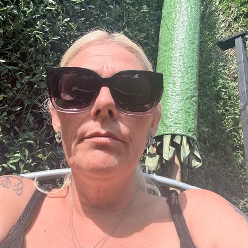 Reviewer taking a selfie outdoors wearing the oversized, square Polarized Fit Over Sunglasses.