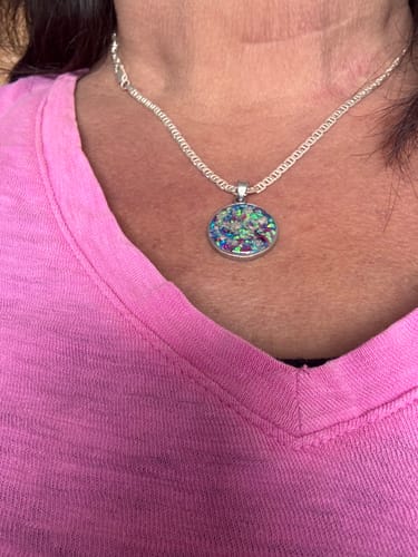 Customer wearing the Circle Opal Pendant with Ash, showcasing the colorful, iridescent crushed opal design.