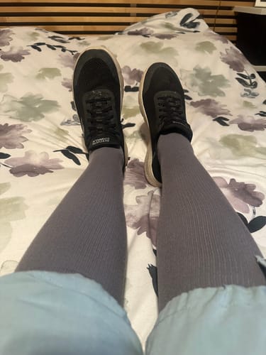 Reviewer's legs wearing grey Eucalyptus Lyocell Compression Socks and black sneakers.