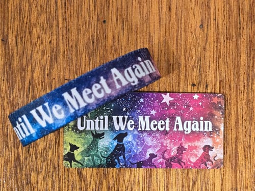 Customer's 'Until We Meet Again' memorial bracelet and its colorful packaging card featuring dog silhouettes.