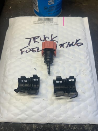 Customer's photo of the temporary fuel fitting and clamps replaced with the SPE Motorsport Injector Return Repair Kit.