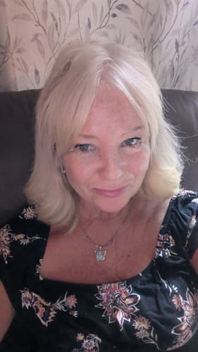 A reviewer's selfie showing her glowing skin after using F-Balm Tallow Balm.