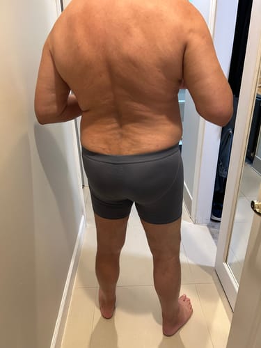 Reviewer from behind, showing the fit of the gray Modal 7in Boxer Briefs.