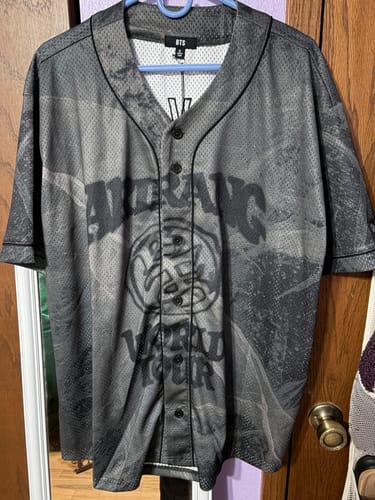 Customer's grey patterned BTS Arirang World Tour jersey hanging up, showing the front graphic design.