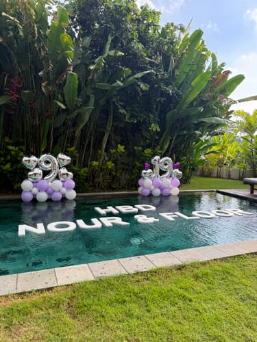 Customer's large floating letters spelling 'HBD NOUR & FLOOR' set up in a beautiful villa pool.