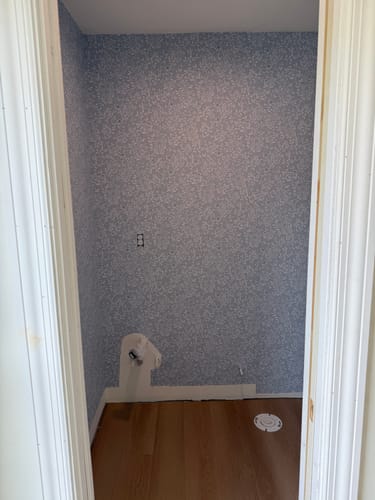 Reviewer's photo of an unfinished room with the non-symmetrical Jessi Wallpaper applied to the walls.