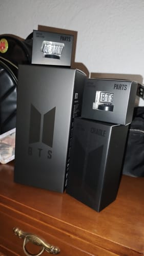 Customer's view of the complete packaging for the BTS Official Light Stick Ver. 4 All Set on a dresser.
