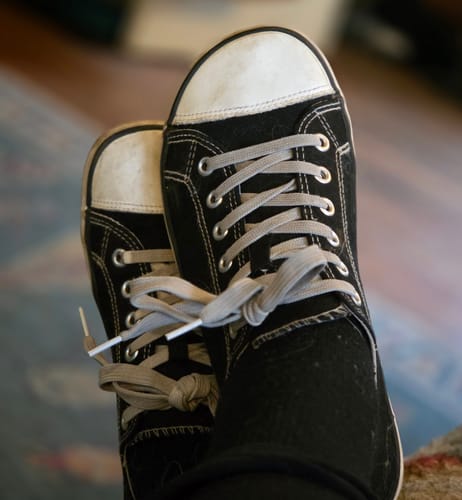 Customer wearing the black canvas Roam I - Barefoot Shoes, showing visible lint on the fabric.