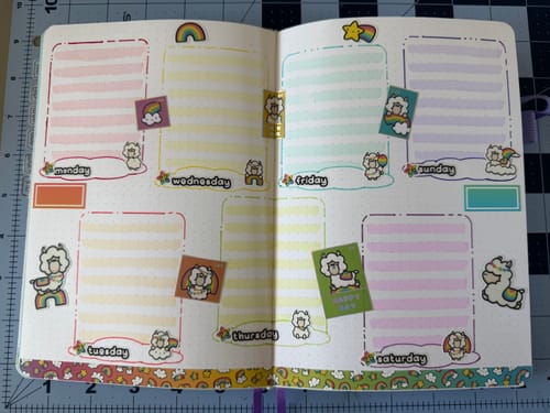 Reviewer's journal showing a colorful weekly layout decorated with stickers and washi tape from the Ultimate Subscription.