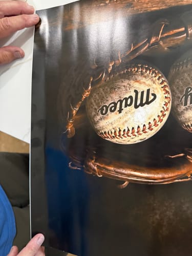 Customer holding their personalized baseball poster, showing a noticeable crease along the left edge of the print.