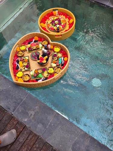 Reviewer's two Floating American Breakfasts, one heart-shaped and one round, in a pool.