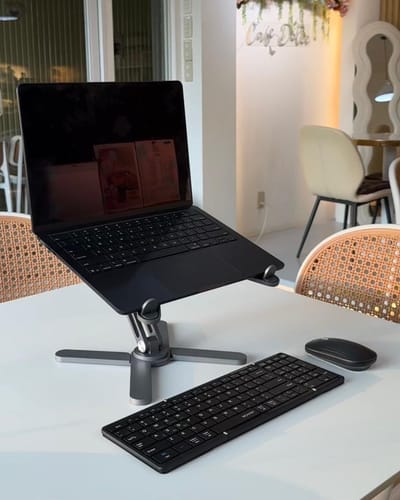 Customer's CMD-X Keyboard and Mouse on a white table with a laptop, showing a portable setup.