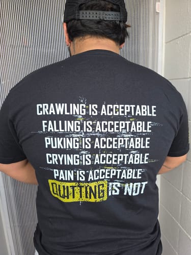 Reviewer showing the motivational message on the back of the black Keep Moving Forward t-shirt.