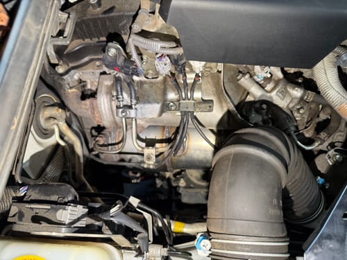 Close-up of a customer's DPF delete dummy version installed in the engine bay of a Toyota Prado, showing a clean fit.